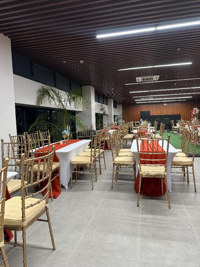 Gold Tiffany chairs · red runners — event rental setup by Chairman Event Rentals in Laguna