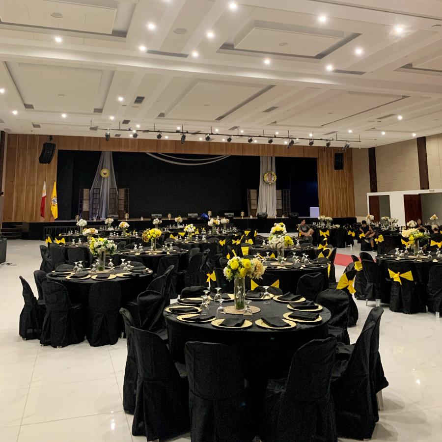 Formal dinner with black covers and floral centrepieces