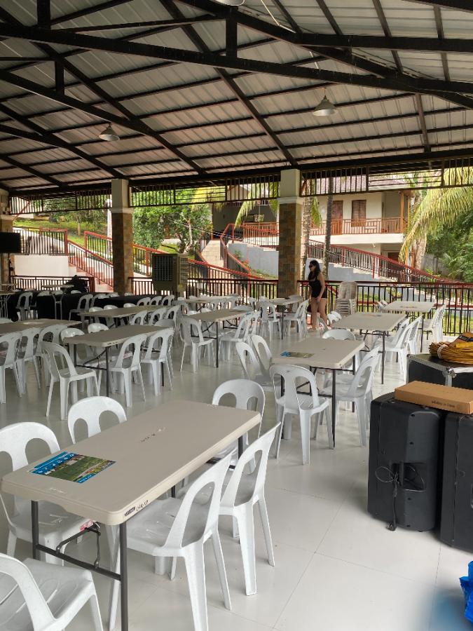 Poolside pavilion · bare tables — event rental setup by Chairman Event Rentals in Laguna