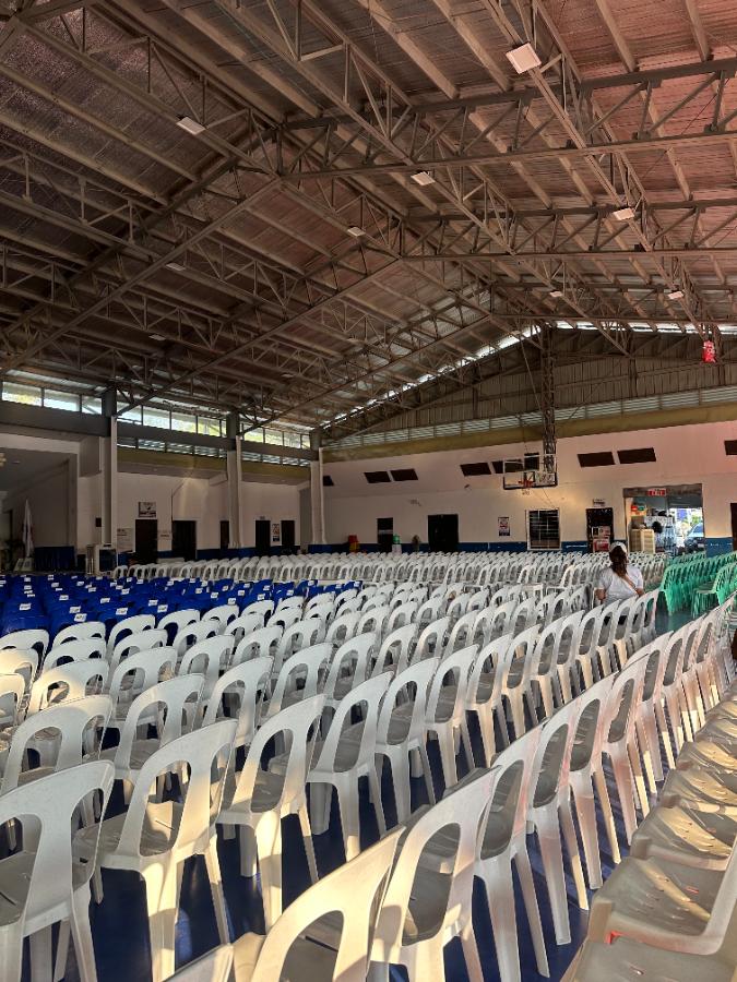 Rows of monobloc chairs set up for a ceremony in Laguna