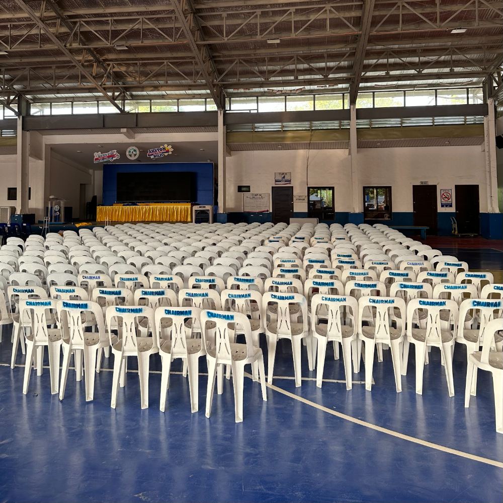 Hundreds of monobloc chairs arranged for a ceremony in Laguna