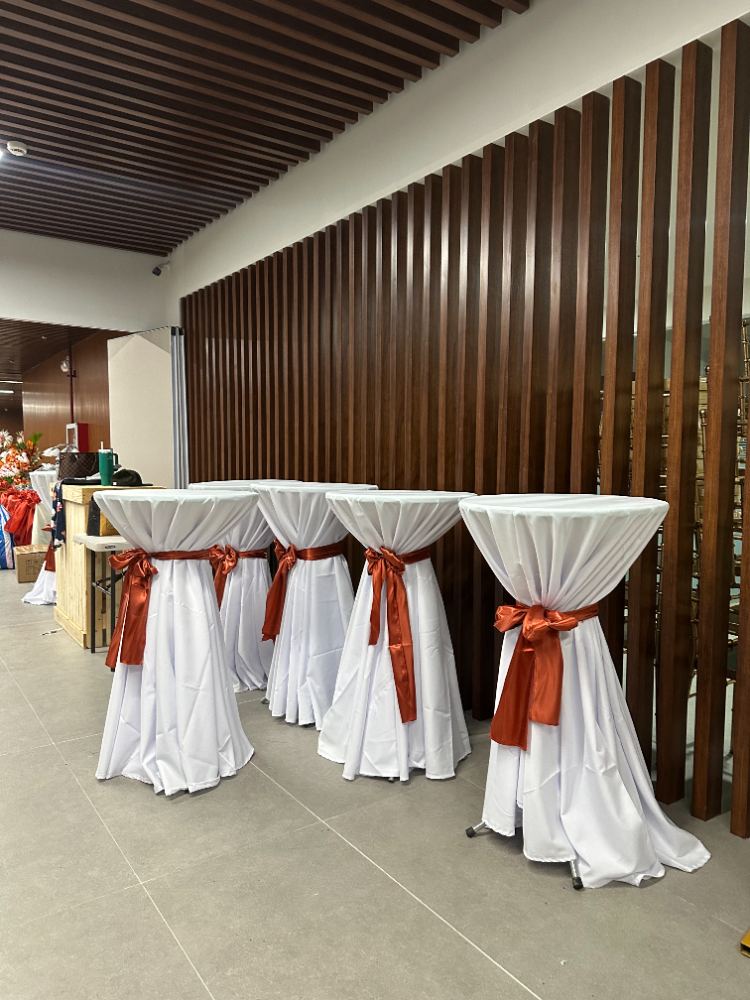 Cocktail table rental with white spandex cover and ribbon